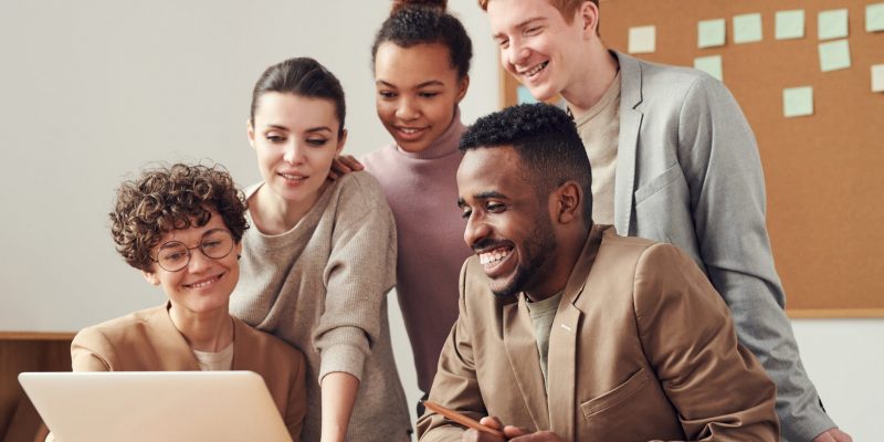 photo of people looking on laptop